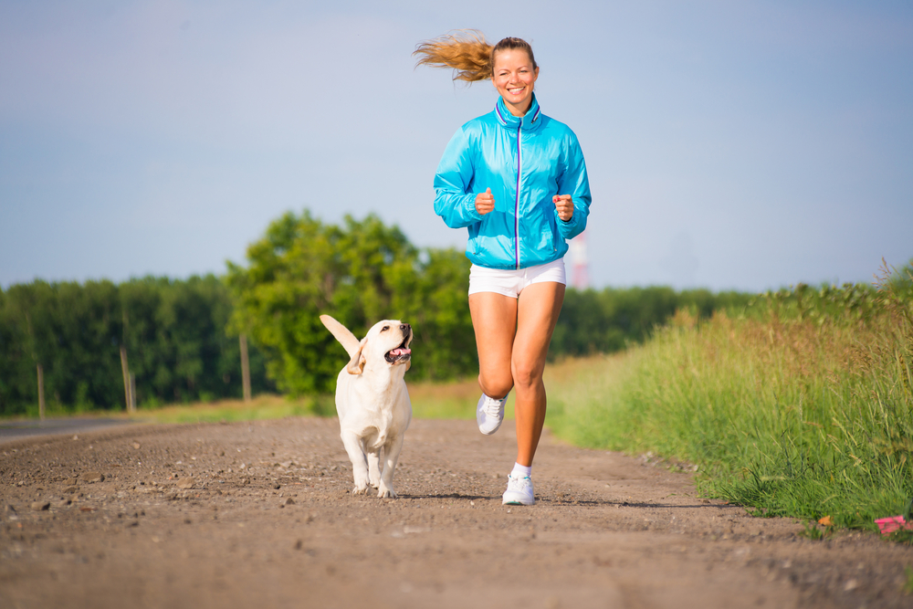 woman exercising with dog